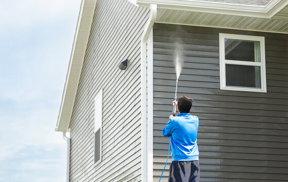 Clean home exterior with sparkling windows and freshly washed driveway